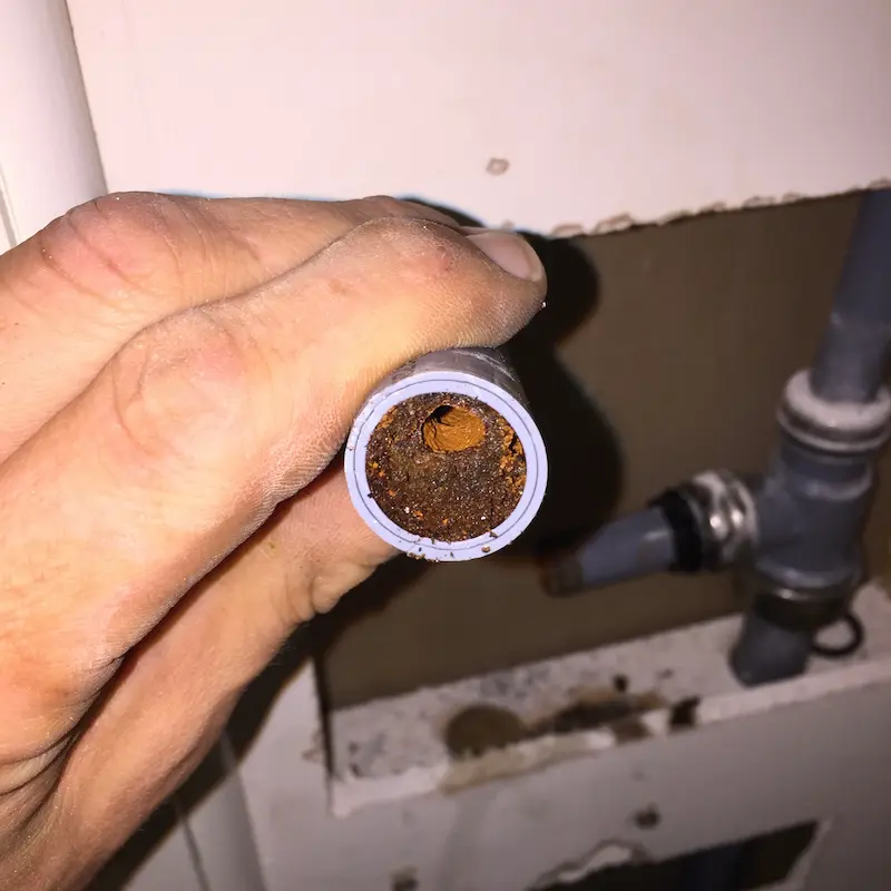 A pipe cut in half showing a blockage